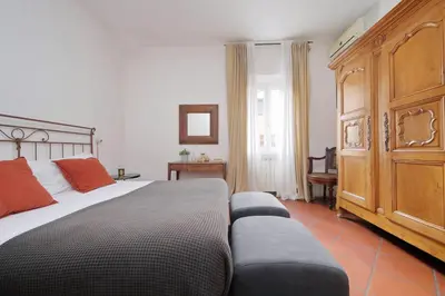 a bedroom with a large bed and a couch at Pantheon 2 Bedrooms in Rome