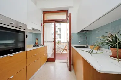a kitchen with a sink and a large tv at YCH-Appartamento Luminoso a San Pietro in Rome