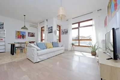 a living room with a white couch and a tv at YCH-Appartamento Luminoso a San Pietro in Rome