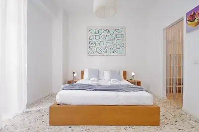 a bedroom with a large bed with white walls at YCH-Appartamento Luminoso a San Pietro in Rome