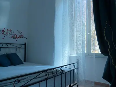 a bedroom with a bed and a window at Holiday Home Il Sogno A San Pietro in Rome