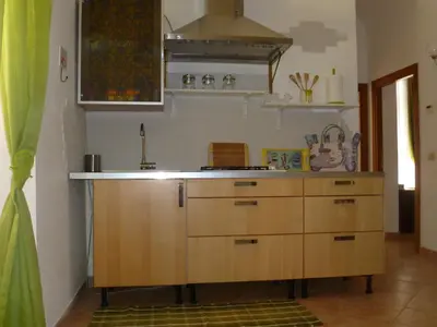 a kitchen with wooden cabinets and a stove at Holiday Home Il Sogno A San Pietro in Rome