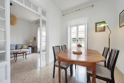 a dining room with a wooden table and chairs at suity I cozy belli apartment in Rome