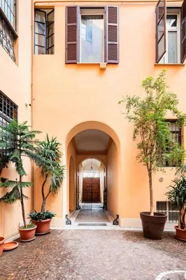 an entrance to a building with trees in front of it at Domus Paolina Arenula in Rome