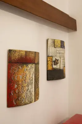 two pieces of art hanging on a wall at Casa vacanze Holly in Rome