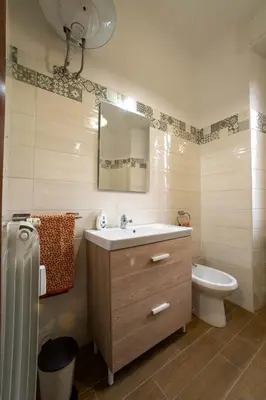 a bathroom with a sink and a toilet and a mirror at Casa vacanze Holly in Rome