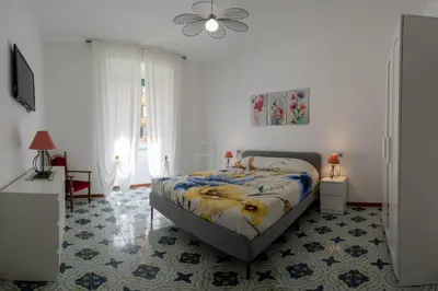 a bedroom with a bed and a ceiling fan at Casa vacanze Holly in Rome