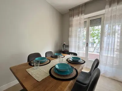 a dining room with a wooden table and chairs at Vatican Family House 2 Baths & 3 Rooms in Rome
