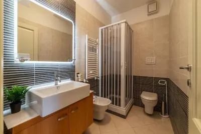 a bathroom with a sink and a toilet and a shower at GuestHost - Porta Portese Modern Terrace Apartment in Rome