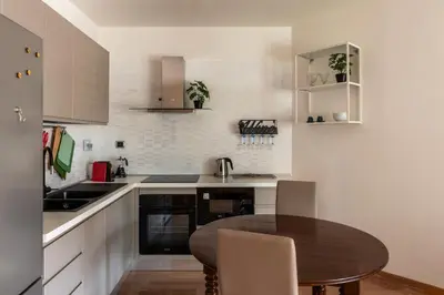 a kitchen with a table and a sink and a counter at GuestHost - Porta Portese Modern Terrace Apartment in Rome