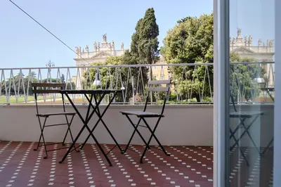 a table and two chairs on a balcony at San Giovanni Retreat in Rome