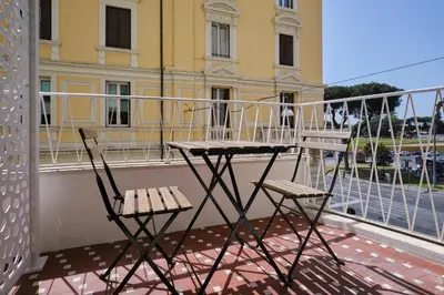 a table and two chairs on a balcony at San Giovanni Retreat in Rome