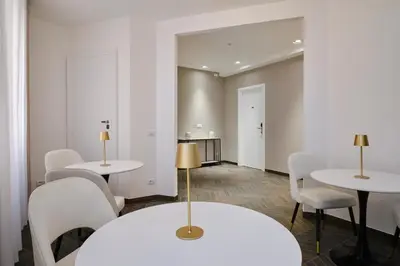 a room with two tables and white chairs at San Giovanni Retreat in Rome