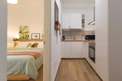 a small bedroom with a bed and a kitchen at Casa Coppedè in Rome