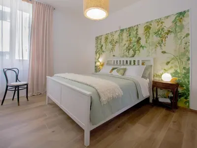 a bedroom with a white bed and a chair at Casa Coppedè in Rome