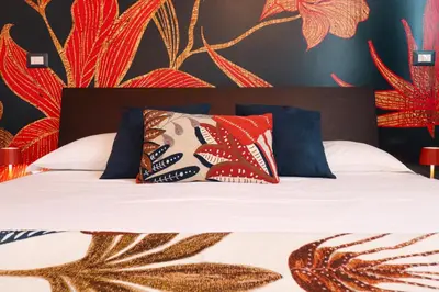 a bedroom with a bed with colorful pillows at Margot - Quiet and Elegant with Free Parking in Rome