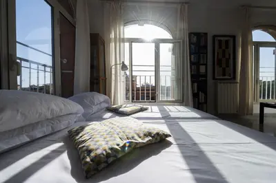 a bedroom with a bed and a large window at St John Basilica Lovely Tower Apartment in Rome