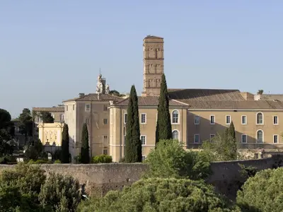 an old building with a tower in the background at St John Basilica Lovely Tower Apartment in Rome