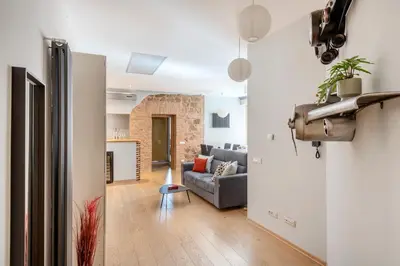 a living room with a couch and a table at Première in Rome