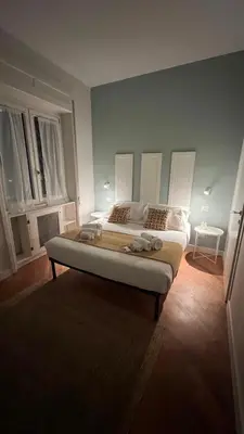 a bedroom with a large bed in a room with windows at Archimede 35 One step away from the center in Rome