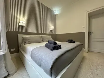 a bedroom with a bed with two towels on it at rome via veneto in Rome