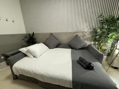 a bedroom with a large bed with white sheets and pillows at rome via veneto in Rome