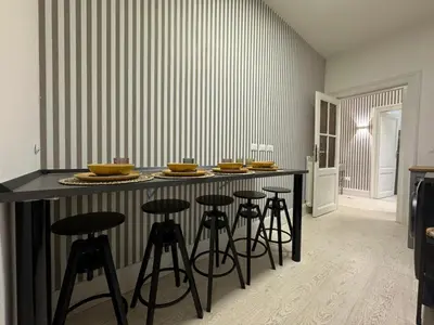 a kitchen with a bar with stools in it at rome via veneto in Rome