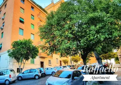 a row of cars parked in front of a building at Raffaello Apartment in Rome