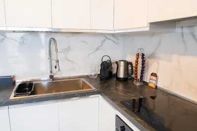 a kitchen with a sink and a counter top at Attico Esclusivo Trastevere with Rooftop Terrace in Rome