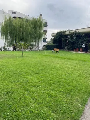 a park with a bench in the grass at Paki House Luxury in Rome