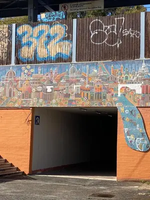 a tunnel with a mural on the side of a building at Paki House Luxury in Rome