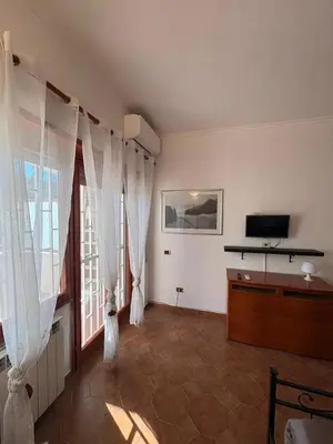 a living room with white curtains and a television at Paki House Luxury in Rome