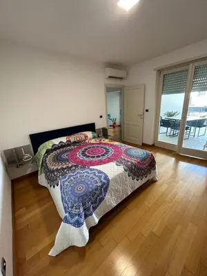 a bedroom with a bed and a wooden floor at Del Vecchio Apartment in Rome