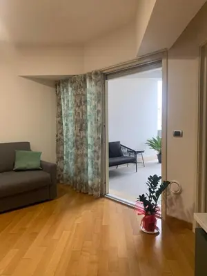 a living room with a couch and a sliding glass door at Del Vecchio Apartment in Rome