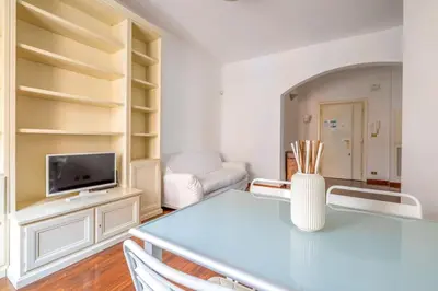 a living room with a table and a tv at St Peter House by Varental in Rome