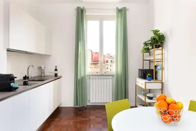 a kitchen with a table with oranges on it at Idyllia - Bright and modern apt in Rome