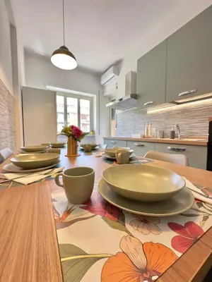 a kitchen with a wooden table with plates on it at La Casa di Umberto in Rome