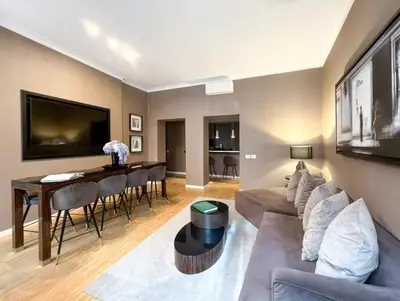 a living room with a couch and a table at The Condotti - Luxury serviced apartment in Rome