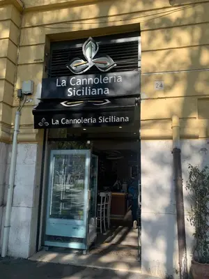 a sign for a restaurant on the side of a building at Appartamento degli Eroi in Rome