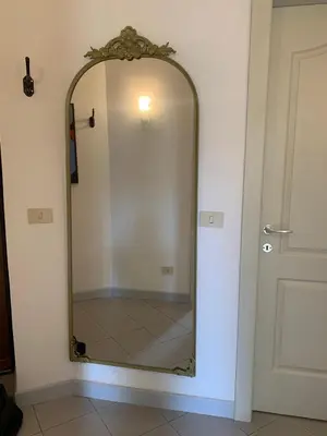 a mirror on a wall next to a door at Appartamento degli Eroi in Rome