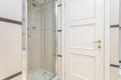 a shower with a glass door in a bathroom at Sant'Andrea - Opulence Apartment in Rome