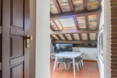 a table and chairs in a room with a ceiling at Domus Tempio Deluxe, Roma Centro in Rome