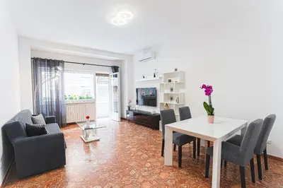 a dining room with a white table and chairs at Domus Leo Roma in Rome