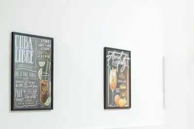 two framed chalkboard posters on a wall at Domus Leo Roma in Rome