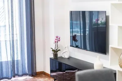 a living room with a desk and a mirror at Domus Leo Roma in Rome