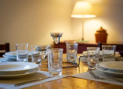 a wooden table with plates and glasses on it at Yes Holiday Rome in Rome