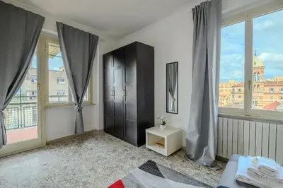a bedroom with a black cabinet and large windows at Opera 65 Roof Terrace in Rome