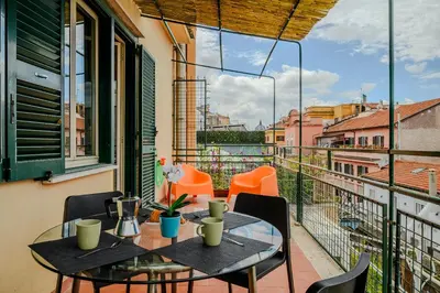 a table and chairs on a balcony with a view at Opera 65 Roof Terrace in Rome