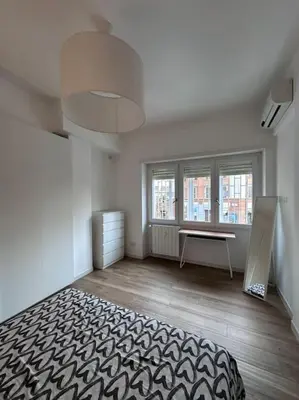 a bedroom with a bed and a desk in it at Otium - Tarquinia in Rome