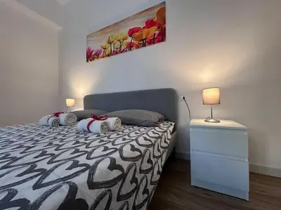 a bedroom with a bed and a painting on the wall at Otium - Tarquinia in Rome